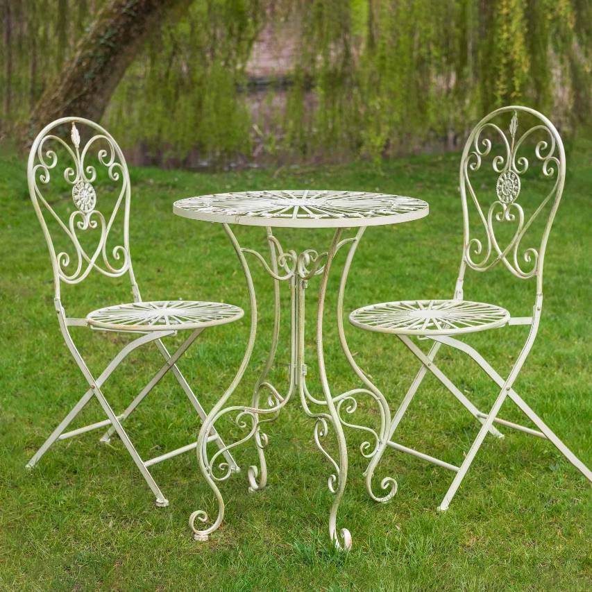 Cream Blaisdon bistro set placed on grass with a leaning willow tree in the background.