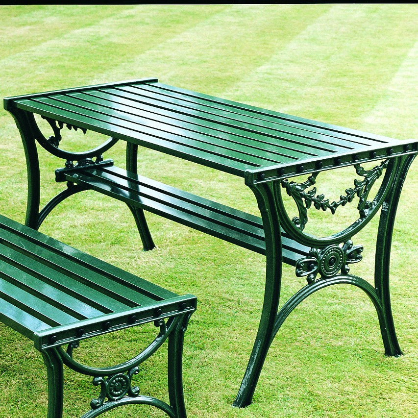 Edwardian table in green aluminium standing on well-kept lawn with stripes