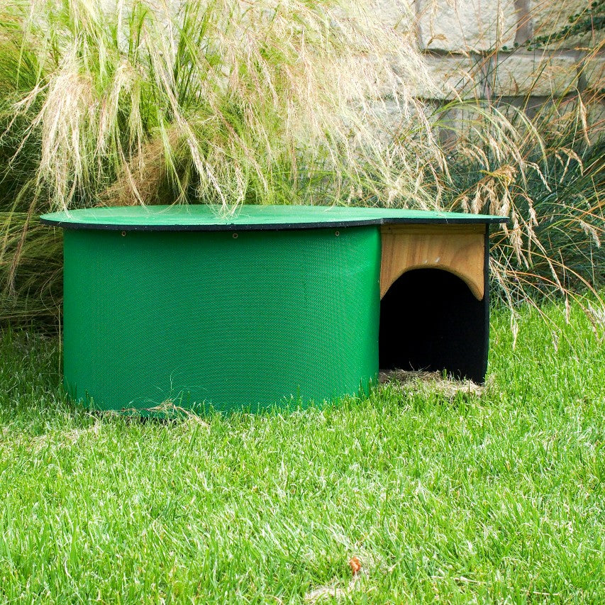 Hogilo hedgehog house on lawn in front of stipa and stone wall