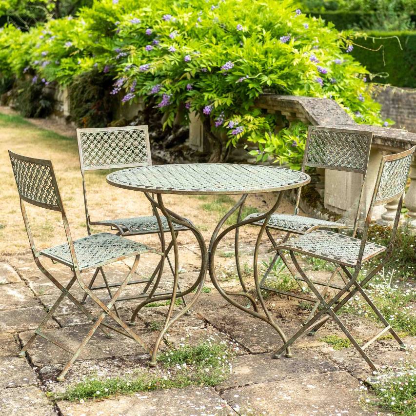 Ascalon Marlborough 5 piece bistro set in antique blue rust on patio with wisteria in background.