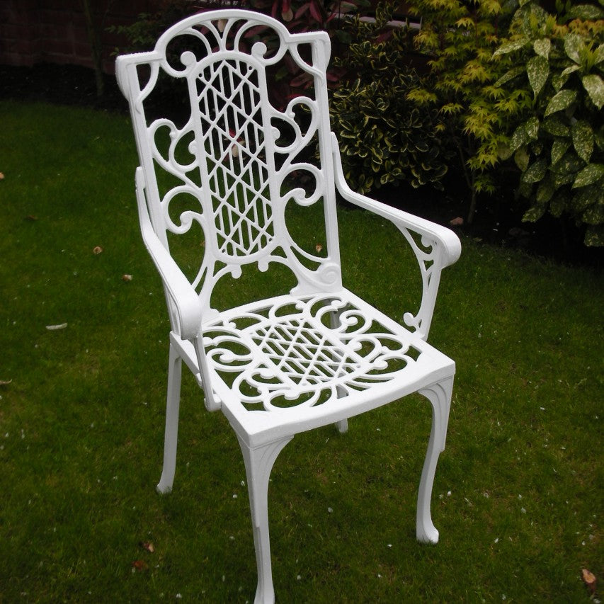 Jardine Leisure Victorian carver chair in gloss white finish standing on lawn next to shrub border