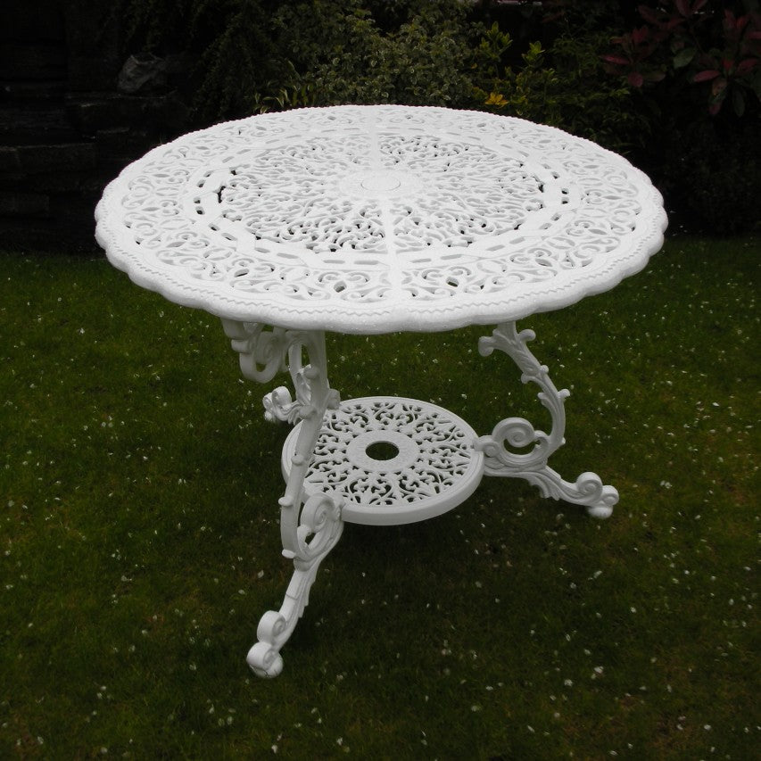 Jardine Leisure Victorian round table in gloss white standing on lawn next to border