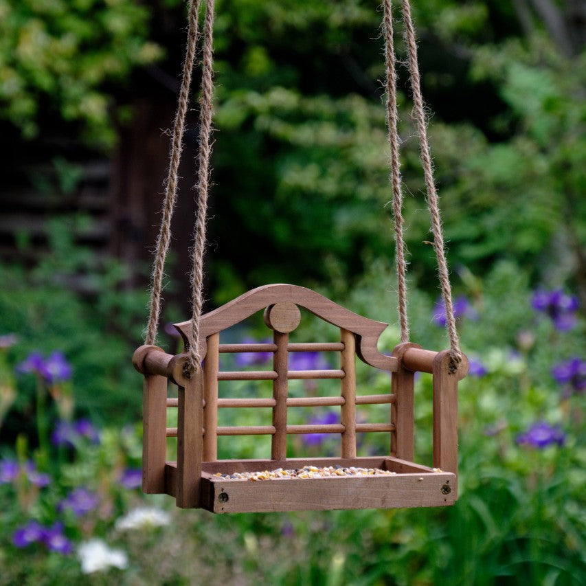Lutyens swing seat feeder with blue iris in background