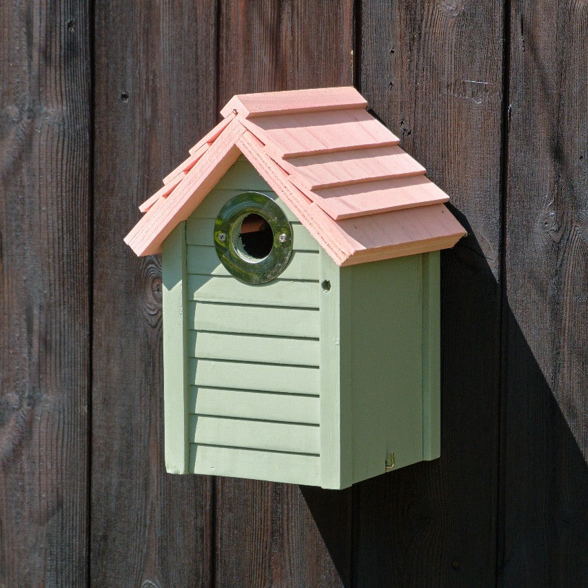 New England nestbox in sage green attached to wooden slatted fence