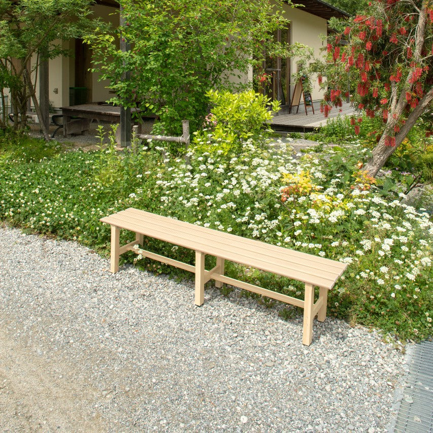 VegTrug aluminium bench light wood effect on gravel path next to flower border